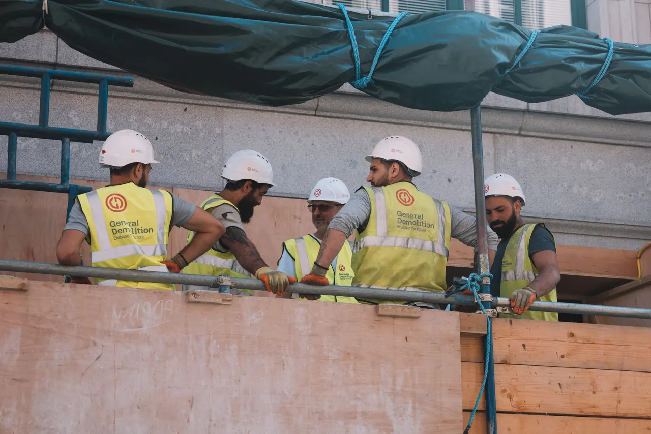 A construction crew in hard hats and high-visibility vests on site